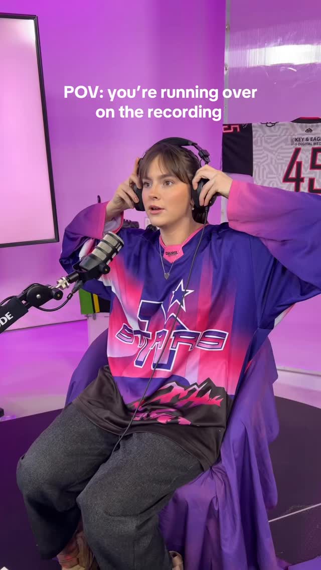 Emma in a Stars jersey wearing headphones during a recording