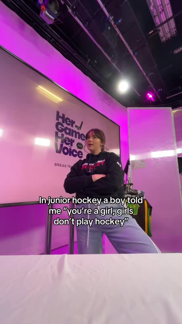 Emma Stigter recording in front of the Her Game, Her Voice branded studio wall